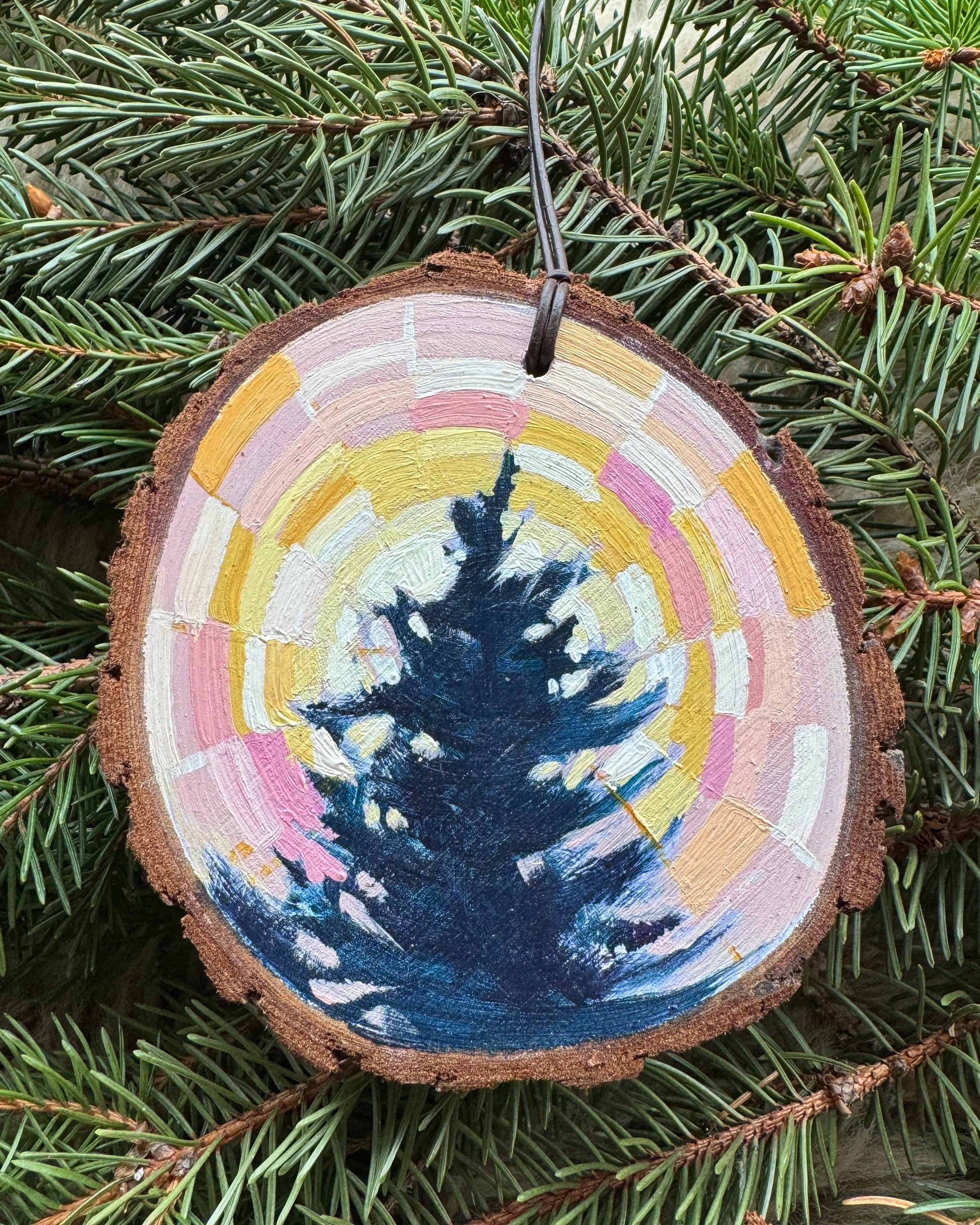 Decorative ornament with a painted design on a branch